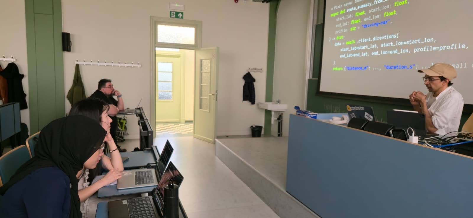 Hands-on GeoAI lab with students coding on laptops